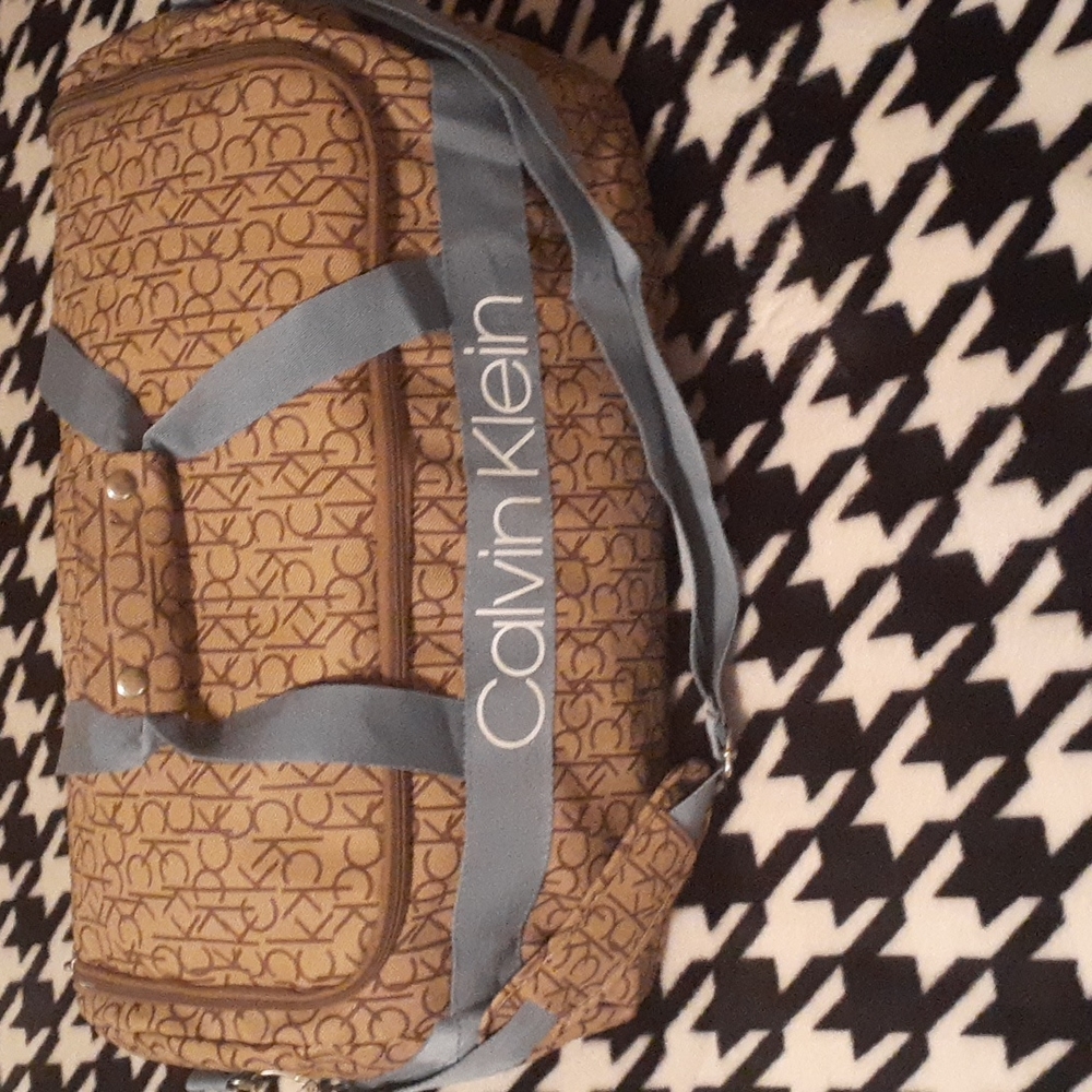 NWOT Calvin Klein tan monogram duffel bag with blue accents